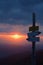 Tourist signpost on a mountain road at sunset