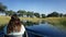 Tourist sitting in the front of a makoro, Okavango Delta, Botswana, Africa