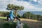 Tourist sitting on the grass near a tree opposite the Black Sea on the southern coast of the Crimea peninsula