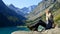 Tourist sitting on rock at Gaube lake. Hautes Pyrenees.