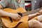 Tourist sitting in the tent, play the guitar and sing songs