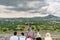 Tourist sitting  on the top of the largest ruins of the architecturally significant Mesoamerican pyramids  in Teotihuacan, an