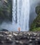 Tourist on the Skogafoss waterfall background. Travelling on Iceland. Tourist in the famouns place in Iceland.