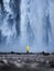 Tourist on the Skogafoss waterfall background. Travelling on Iceland. Tourist in the famouns place in Iceland.