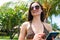 Tourist with smart phone in front of palm trees on beach