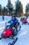 Tourist snowmobiles moves along the ice