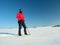 Tourist with snowshoes walk in snowy drift. Sunny freeze weather.