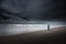 Tourist on South Jetty Beach Oregon Coast Dark Cloudy day