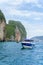Tourist speedboat near a limestone rock