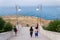 Tourist on stairs leading to dramatic cliffs over Adriatic sea beside beach Lama Monachile in Polignano a Mare, Italy