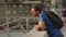 Tourist standing on bridge, enjoying city view, young man on a sightseeing tour