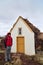 Tourist standing in front of historic farmhouse