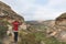 Tourist standing with outstretched arms and looking at the panoramic view in the majestic Golden Gate Highlands National Park, tra