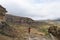 Tourist standing with outstretched arms and looking at the panoramic view in the majestic Golden Gate Highlands National Park, tra