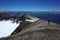 Tourist stands on edge of volcano Puyehue crater, Puyehue National Park