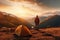 tourist stands near a tent against the backdrop of mountains at sunset. View from back, Generative AI