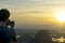 Tourist staying on the top of mountain and taking a photos of Marble mountains