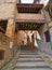 Tourist on the steps in old historic alley in the medieval village of Anghiari near city of Arezzo in Tuscany, Italy