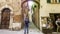 Tourist stops to take a picture in front of a street in Montepulciano