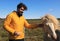 Tourist stroking an icelandic horse.