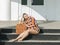 A tourist with a suitcase sits on the steps in front of the clos