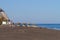 Tourist sunbathing at Black Beach,Santorini, Greece.