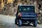 Tourist SUV car cruising along a rugged route through the gorge that was once a former railway line built by prisoners of war