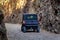 Tourist SUV car cruising along a rugged route through the gorge that was once a former railway line built by prisoners of war