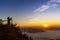 Tourist take photo the Landscape of the mountain and sea of mist in winter sunset / sunrise view from top of Doi Pha Tang mountain