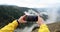 Tourist takes off phone beautiful view of nature of mountains of forest in fog