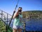 A tourist takes photographs during a Mediterranean cruise off the coast of Alanya, Turkey. A young adult girl holding a camera in