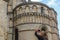 A tourist takes photos with her mobile phone from the medieval style catholic cathedral in the city of Norwich, England