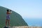 A tourist takes a picture of the panorama of Porto Katsiki in Lefkada