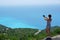 A tourist takes a picture of the panorama of Porto Katsiki in Lefkada