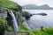 Tourist takes selfie against background Skardsafossur waterfall, Faroe Islands