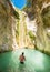 Tourist taking a bath inside Nidri Waterfall in Lefkada Greece