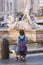 Tourist taking a photo of 16th century Fountain of Neptune located in Piazza Navona, Rome, Italy