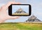 Tourist taking photo of mont saint-michel abbey