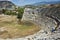 Tourist taking photo on ruins of Theatre in Letoon Ancient City in village Kumluova, Turkey. Sunny day, Greek culture