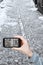 Tourist taking photo of snowy cobblestone road