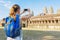 Tourist taking picture of the Angkor Wat complex in Cambodia