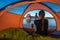 Tourist taking picture with her phone Tent Camping Lone Rock Lake Powell