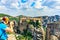 Tourist taking a picture Holy Monastery of Varlaam - one of Eastern Orthodox monasteries located in rock formation Meteora