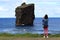 A tourist taking picture of the iconic wild rock formations next to Mosteiros in SÃ£o Miguel island