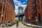 Tourist taking pictures of iconic Manhattan Bridge and Empire State Building view from Washington Street in Brooklyn, New York