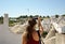 Tourist taking travel picture with mirrorless camera of Alberobello trulli cityscape during summer holidays. Unrecognizable female