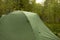 Tourist tent in forest. Tent for sleeping in nature. Equipment for going to park