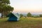 Tourist tent on among meadow in the sunset overlooking mountains. outdoors camping.