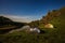 Tourist tents at riverbank at summer night