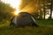 Tourist tents on riverbank at sunrise